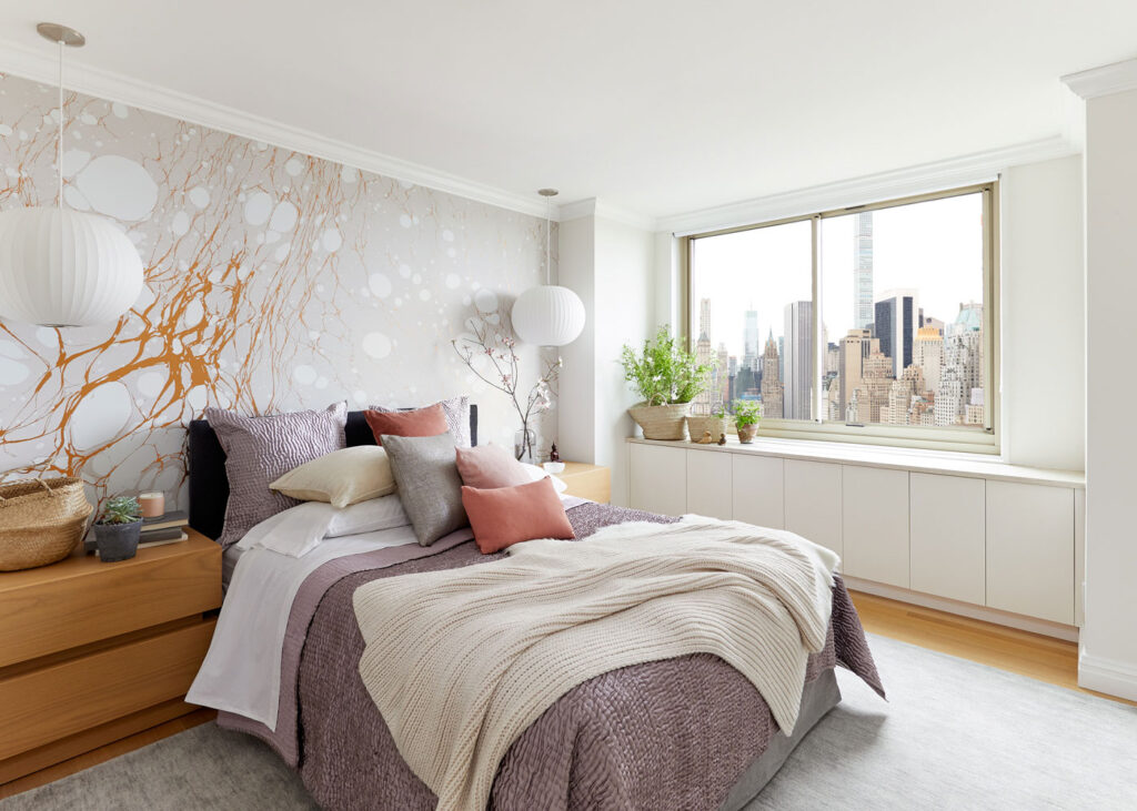 A Manhattan guest bedroom got a global, serene makeover with Danish inspired touches and a statement Calico wallpaper. Design by Laurie Blumenfeld Design. Photography by Tim Williams.